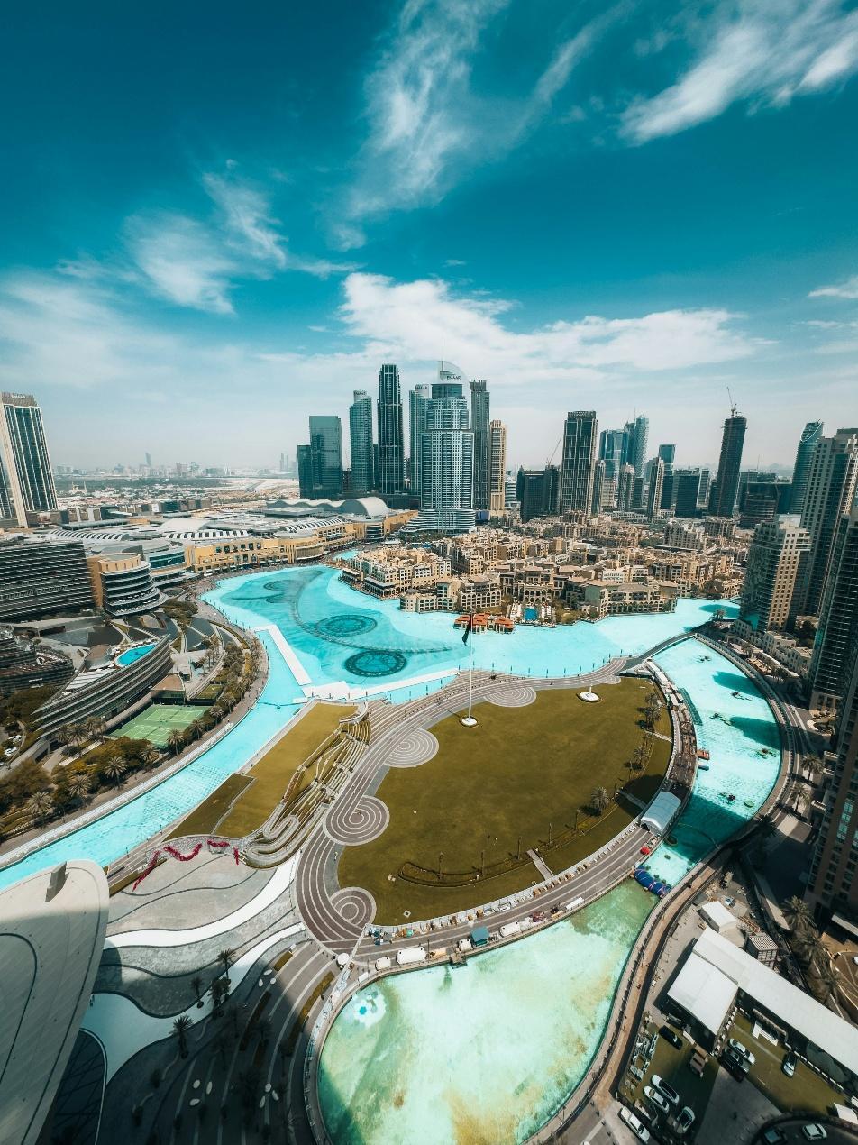Dubai skyline with a large, blue water feature.