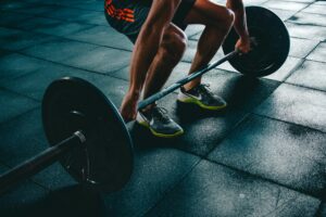 a close-up of a man in a gym lifting weights